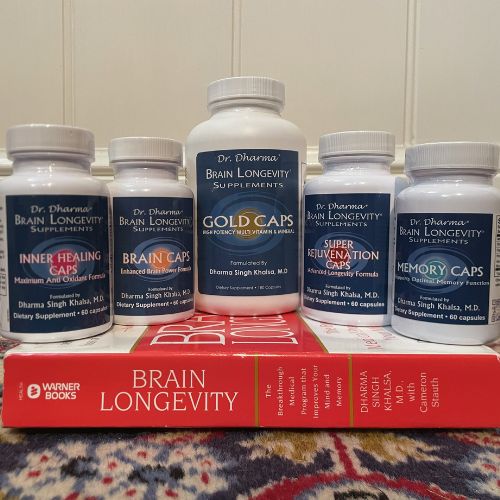 The five Dr. Dharma formulas standing on a copy of Brain Longevity